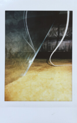 A specific view through a room. A specific movement through space - a body can't, but a cable can make. Close - but with distance. No physical connection between the objects and the cable. A sphere between them – like between an island and the coast. An island disconnects from the surrounding area. A cable connects two objects (plug and screen) like a bridge. It's a bridge you can never walk on. It's a bridge which allows us to connect with others, with the outside world. We connect trough screens. Screens are an endless road.